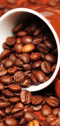 This live wallpaper features a realistic close-up of a coffee cup resting on top of a mound of coffee beans
