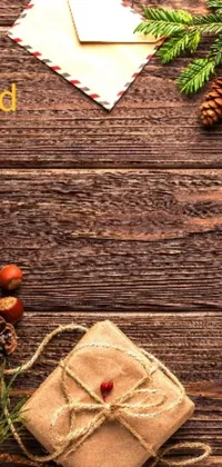 This phone live wallpaper features a colorful present with a ribbon on a rustic wooden table