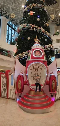 Looking for a festive live wallpaper for your phone? Check out this fun scene featuring a giant Christmas tree, interactive elements, Japanese mascot, shopping mall, and rocket ship