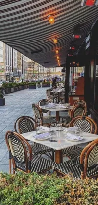 This phone live wallpaper showcases a sophisticated outdoor dining area in Chicago, complete with arranged tables, chairs, and intricate place settings