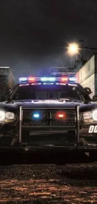This live wallpaper for your phone features a realistic image of a police car parked in front of a building at night