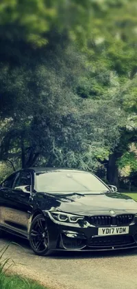 Enhance your phone screen with this dynamic live wallpaper featuring a stylish black BMW parked on a roadside