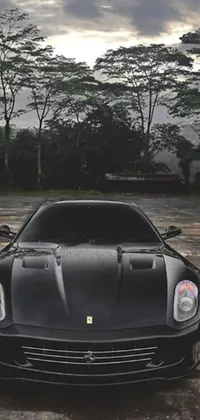 This lively phone wallpaper showcases a sleek black sports car parked in an urban parking lot