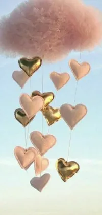 This phone live wallpaper features heart shaped balloons in shades of pink and gold, surrounded by fluffy cotton clouds and playful putti