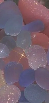 This phone live wallpaper features a close-up shot of some sea glass fragments in extreme detail