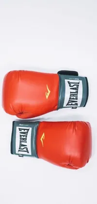 Fight your way through your day with this stunning live wallpaper featuring a pair of bright red boxing gloves on a flat lay white surface