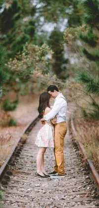 This live wallpaper features a romantic couple standing on train tracks with a forest backdrop