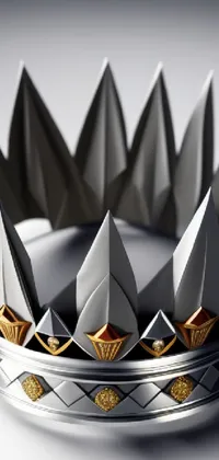 Get mesmerized with this stunning phone live wallpaper that features a silver and gold crown on a table