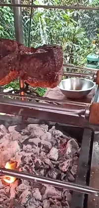 This live wallpaper features a realistic animation of a large piece of meat sizzling on top of a grill