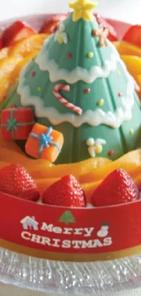 This phone live wallpaper features a delightful cake decorated with Christmas tree-inspired layers of green icing, vibrant candy ornaments, and sparkling sprinkles