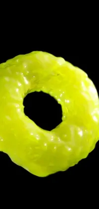 This phone live wallpaper features a striking close-up of a mouth-watering donut on a dark black background