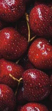 This phone live wallpaper showcases a stunning hyperrealism image of red cherries topped with dewdrops