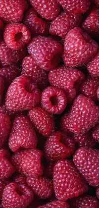 This live wallpaper features a colorful and vibrant pile of raspberries stacked on top of each other