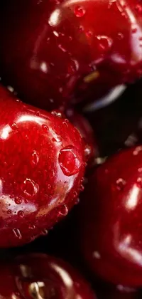 This phone live wallpaper boasts a realistic and detailed image of a bunch of bright red cherries