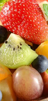 This phone live wallpaper features a stunning close-up of a plate of fruit salad, captured in high-quality detail