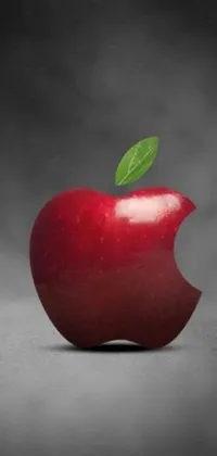 This phone live wallpaper features a hyperrealistic digital rendering of an iconic technology symbol: an apple with a bite taken out of it