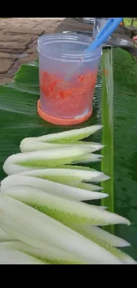 The live wallpaper for your phone features an interesting composition of objects on a green banana leaf