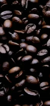 This phone live wallpaper features a pile of coffee beans in various shades of brown, arranged in a realistic and textured manner