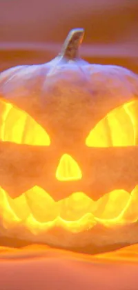 This live wallpaper for your phone features a digital rendering of a spooky carved pumpkin