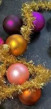This live wallpaper showcases colorful Christmas ornaments, arranged neatly on a table