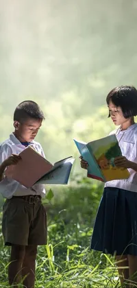 This phone live wallpaper depicts two kids studying in a lush green Thailand field