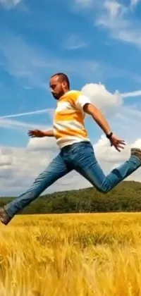 This phone live wallpaper shows a man running through a field, depicted in a jumping float pose