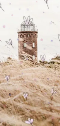 Enjoy a stunning live wallpaper featuring a tall tower amidst rolling hills and green fields
