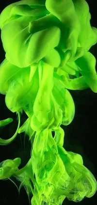 This live phone wallpaper features a close up of neon green fluid on a black background, with pulsating light green waves running through it