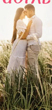 Boost your phone's aesthetics with a graceful and romantic live wallpaper featuring a couple embracing in a meadow of tall grass