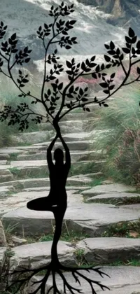 This live wallpaper showcases a relaxing scene of a woman practicing yoga under a tree, with a picturesque mountain in the background