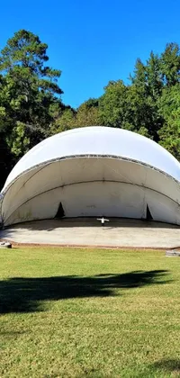 This live wallpaper features a beautiful white tent on a lush green field, captured in full dome format