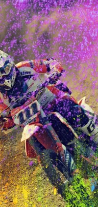 This energetic phone live wallpaper features a man riding a dirt bike against a colourful airbrush painting background, with a playful sprinkle and crumb coating
