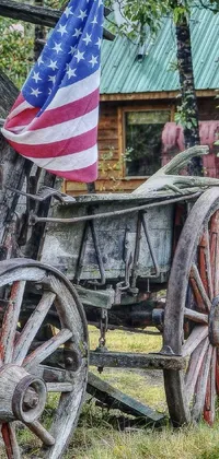 This live wallpaper depicts an old wagon with an American flag draped across it