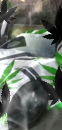Looking for a unique and edgy live wallpaper for your phone? Check out this amazing design featuring a muscle car covered in marijuana leaves set against a backdrop of white laser lights