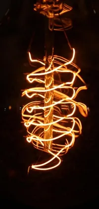 This live wallpaper features a close-up of a light bulb in a dark room with swirls of fire, thick chains, and neon lights