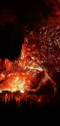 This live wallpaper features a stunning close-up of a fiery sculpture with an alosaurus emerging from the embers