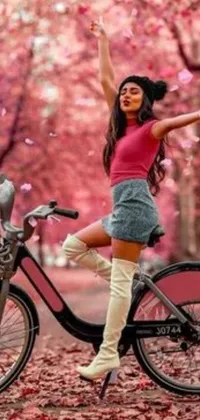 This beautiful live wallpaper features a woman riding on the back of a bike in a stunning landscape