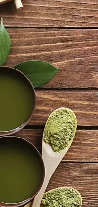 This live wallpaper features two bowls of matcha placed on a wooden table with a relaxing, green water background