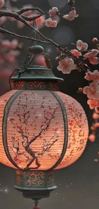 This live phone wallpaper consists of an exquisite close-up of a hanging lantern from a tree amid a stunning flowery background in shades of pink and green