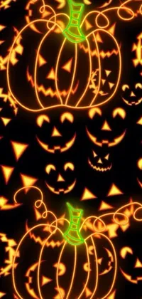 This live phone wallpaper depicts a pattern of glowing pumpkins set against a black background
