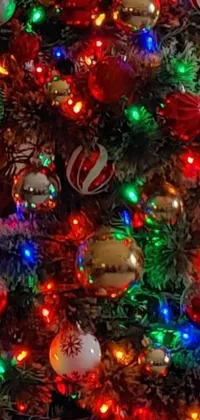 This phone live wallpaper features a stunning close-up view of a beautifully decorated Christmas tree