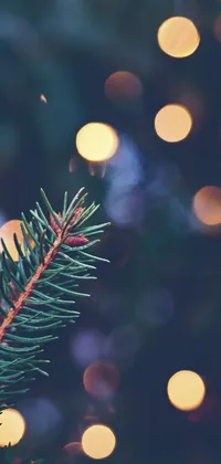 This phone live wallpaper showcases a stunning close-up of a Christmas tree adorned with delicate ornaments and twinkling lights