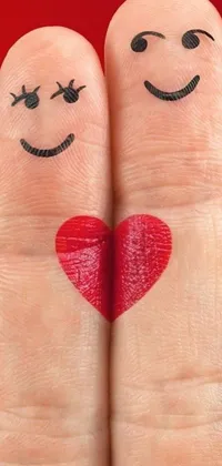 This live wallpaper features two fingers with cheerful faces and a heart drawn on them