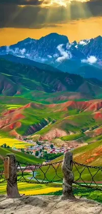 This stunning live wallpaper features a beautiful valley with mountains in the distance, complemented by a colorful small town in the foreground