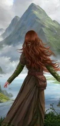 This phone live wallpaper depicts a redhead woman standing on a lush green hillside beside a clear river wearing an earthy flowing dress