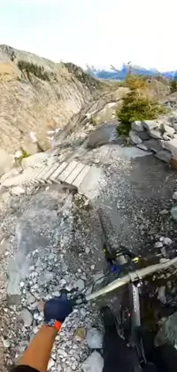 This live wallpaper features a thrilling scene of a mountain biker riding on a rocky trail set in Chamonix
