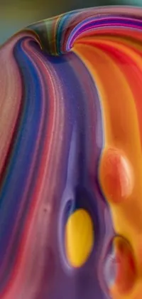 This live wallpaper showcases a close-up of a vibrant and colorful object sitting on a table