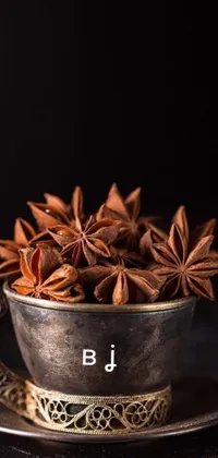 This phone live wallpaper showcases a still life painting of a cup filled with star anise on a saucer