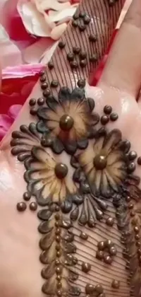 This mobile phone live wallpaper showcases an intricate henna design on a hand