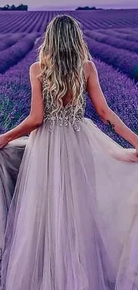 Get this stunning phone live wallpaper featuring a woman standing gracefully in a lavender field adorned in a sparkling, elegant renaissance gown